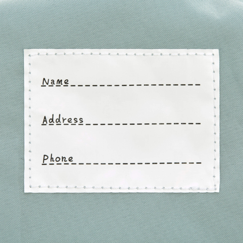 label, name field, stitching, fabric tag, cardboard placeholder