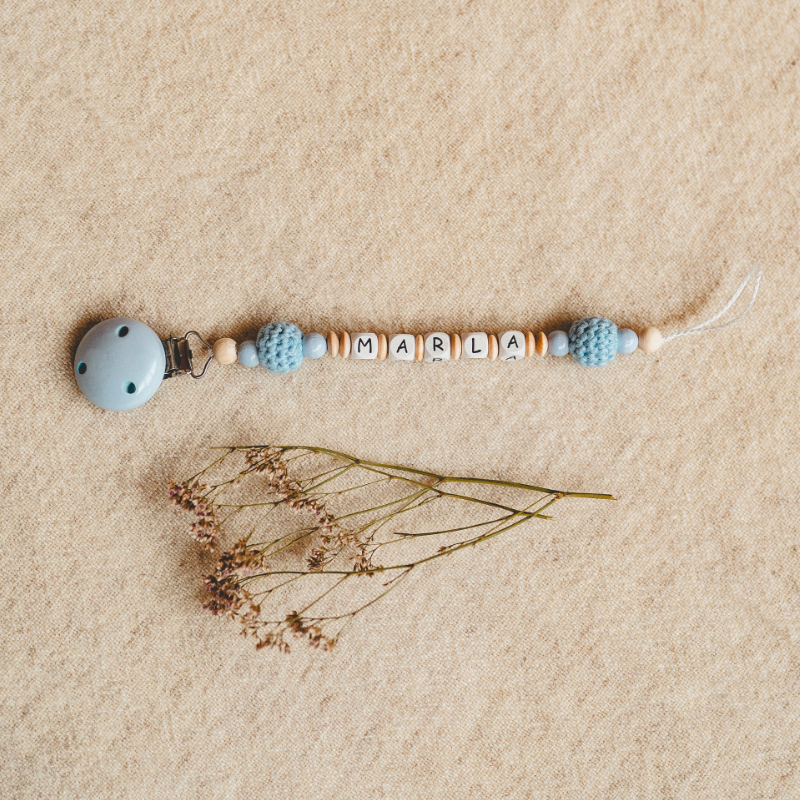 baby rattle, bead chain, name tag, blue pacifier clip, wooden beads