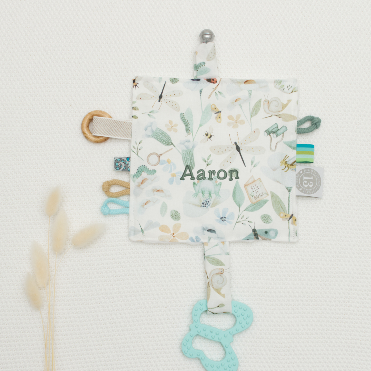 baby taggie, soft toy, peaceful cross shape, teal pacifier clip, personalisierter name Aaron