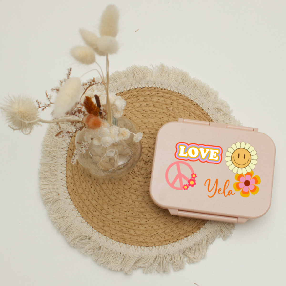 pink case, plastic container, peace sign, flowers, yelo name tag
